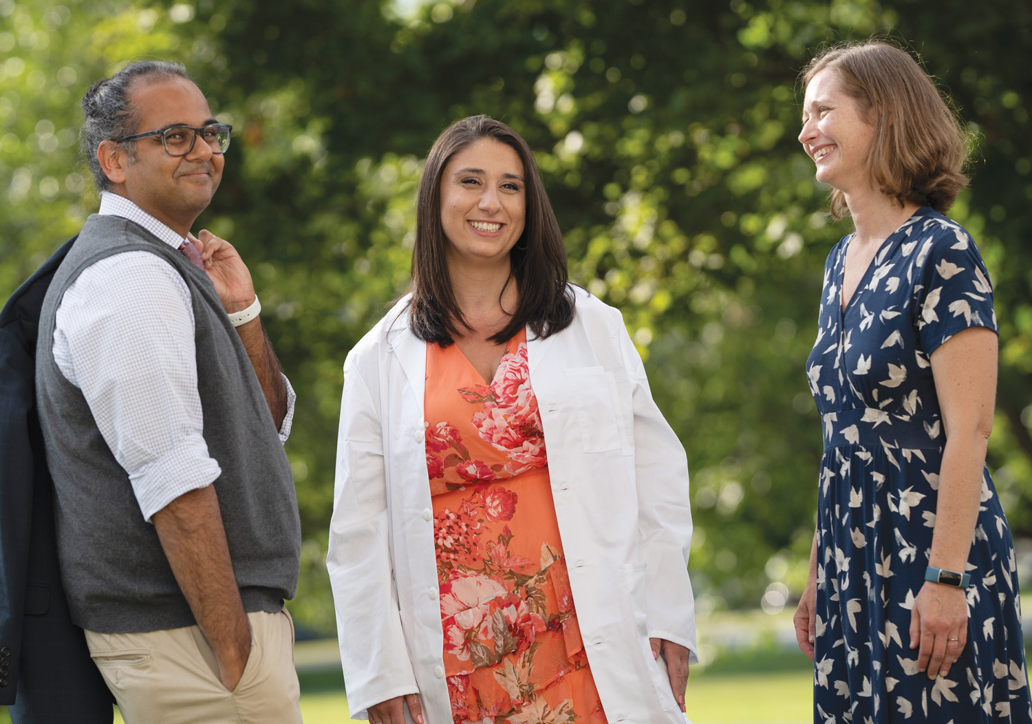 Four years after participating in the inaugural session of Dartmouth Health Care Foundations (DHCF), Jaclyn Engel (center) was welcomed into the Geisel School of Medicine Class of ’26. DHCF co-leaders Manish Mishra MED’05, MPH’09 (left) and Elizabeth Carpenter-Song, PhD, D’01 (right) attended Engel’s White Coat Ceremony.