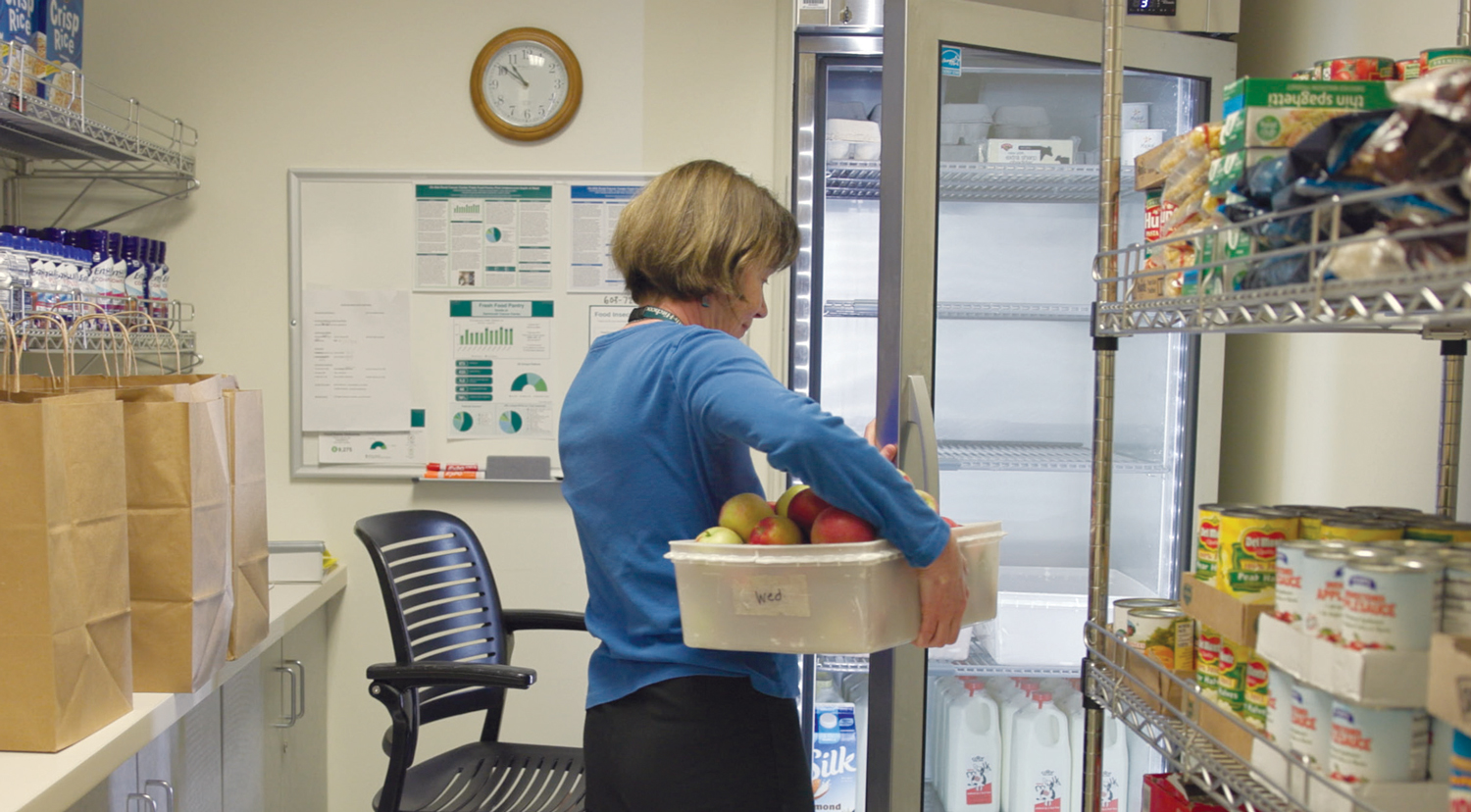 Oncology dietician Dianne Kelecy, MS, RD, LD,  stocks the Dartmouth Cancer Center Food Pantry.