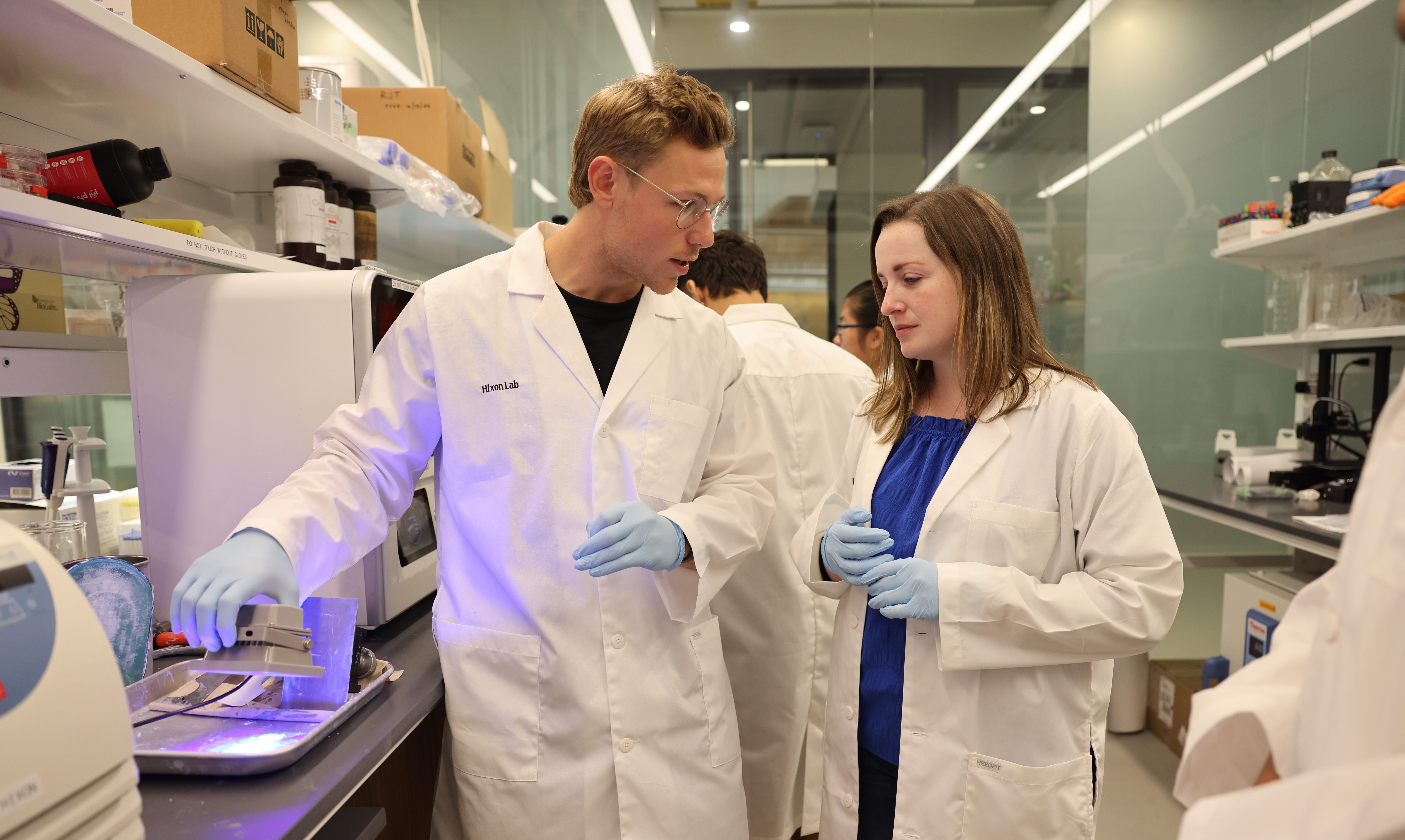 Dr. Katie Hixon, a clinical assistant professor at Dartmouth’s Geisel School of Medicine and Thayer School of Engineering, discusses printing methods and material choice for bone healing with Peter Bertone, surgical innovation PhD candidate, in the process of UV-curing 3D-printed scaffolds.