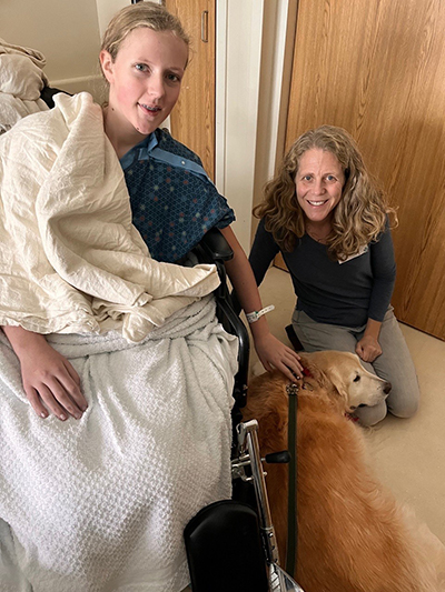 Katherine (left) and Susie receive a visit from a therapy dog at CHaD.