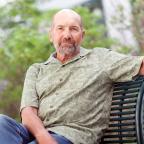 Robert Trembley, MD, sits on a bench outside Dartmouth-Hitchcock Medical Center.