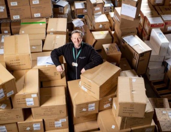 Curtis Lancaster, vice president of supply chain for D-HH, surrounded by donations of PPE. Photo by Mark Washburn