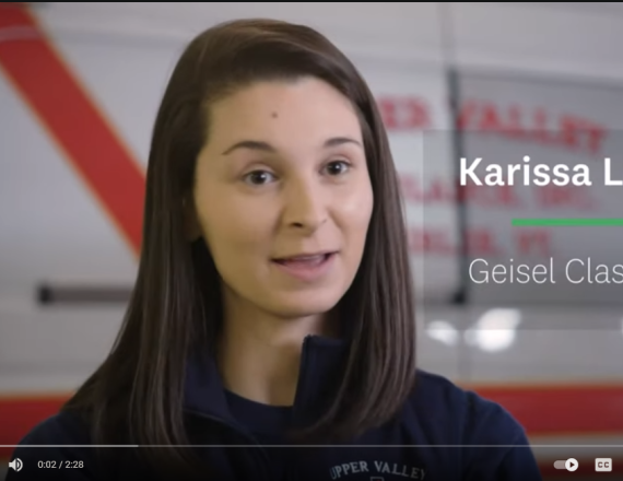 Karissa LeClair, Geisel Class of '21, speaks in front of an ambulance.