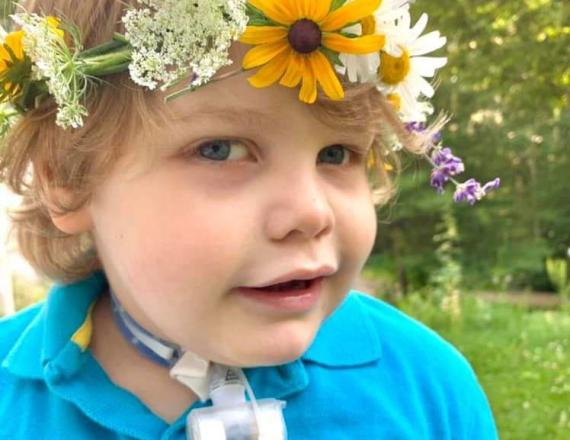 Toddler wearing a crown of flowers