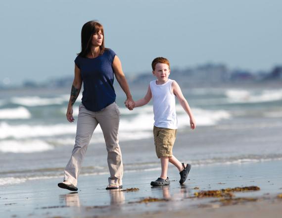 Parent and Child walking on the beach
