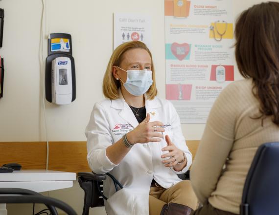Cardiovascular medicine specialist Lauren Gilstrap, MD, speaks to a patient.