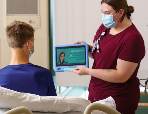 Molly H., an LNA on the pediatric inpatient unit at CHaD, works with an adolescent patient on mental health interventions developed as part of the I*CARE project.