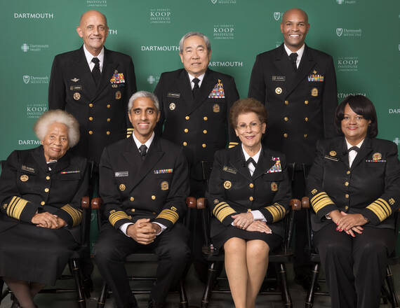 Front row, from left: Joycelyn Elders, 1993-1994, Vivek Murthy, 2014-2017 and 2021-present, Antonia Coello Novello, 1990-1993, Regina Benjamin, 2009-2014.  Back row, from left: Richard Carmona, 2002-2006, Kenneth Moritsugu, 2002-2002, 2006-2007, and Jerome Adams, 2017-2021.  David Satcher, 1998-2002, was unable to attend in person, but shared comments on mental health via a video statement, rounding out the panel to include all of the living U.S. Surgeons General.
