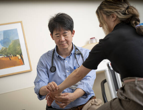 A provider examining a patients wrist