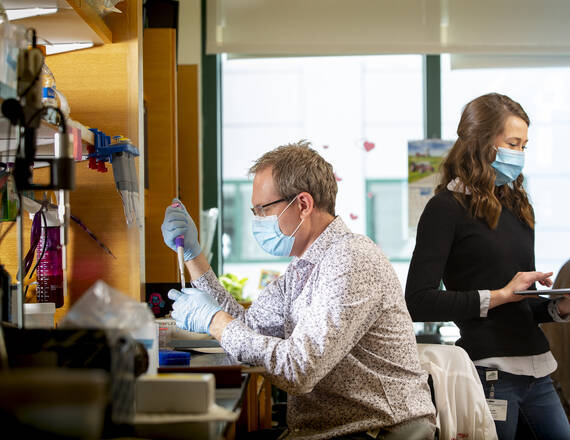 A provider in the lab using a pipet