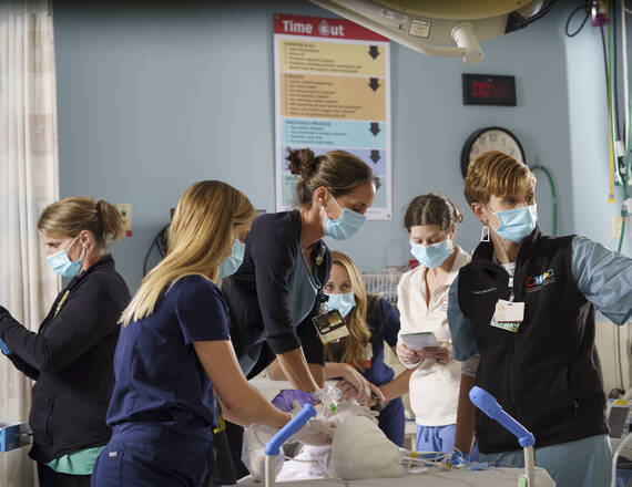 Nurses and doctors administering care to a patient