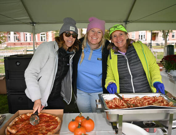 Three volunteers at a food tent helping with the CHaD HERO