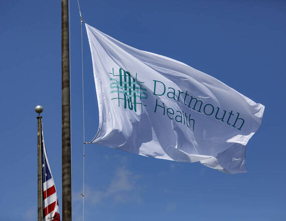 Dartmouth Health flag with blue sky background