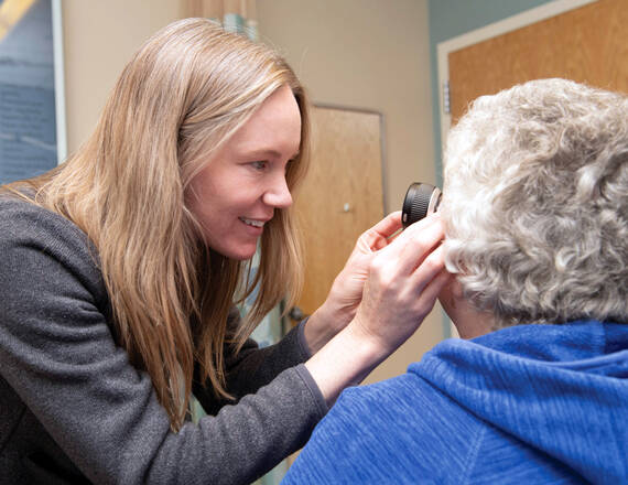Alicia Dagrosa, MD, MBA, RES '21, MED '17, TU '16, examines a patient during Patient Access Week in April.