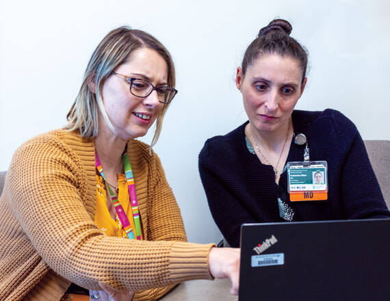 DHMC child psychiatrist Katherine Shea, MD '09, MPH ’15 (right), and behavioral health clinician manager Chase Trybulski, LCMHC, discuss the pediatric collaborative care model for implementing mental health care in pediatric primary care settings.