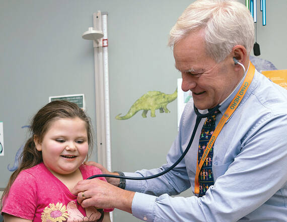 Steve Chapman, MD, medical director of the Northern New England Advocacy Collaborative, a pediatrician at Dartmouth Health Children's, and Boyle Chair in Advocacy and Community Pediatrics at Geisel School of Medicine, examines 5-year-old patient, Serenity.