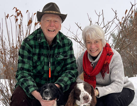 The Todds pose with their two dogs in the snow.