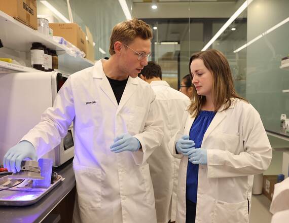 Katie Hixon and student in the lab