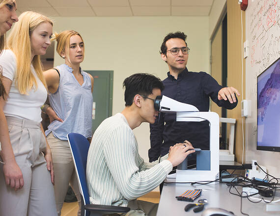 Students in DALI lab on microscope
