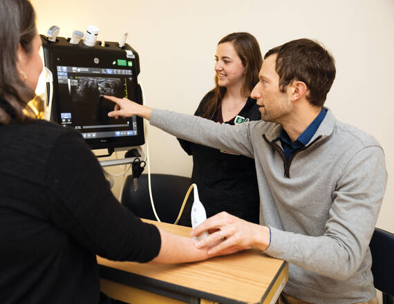 Researchers looking at a computer screen