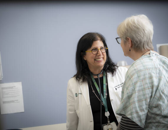 Linda Vahdat, MD, MBA interacting with patient